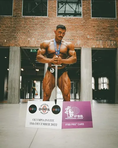 Darren Farrell's client Josh with his pro card and Olympia invite